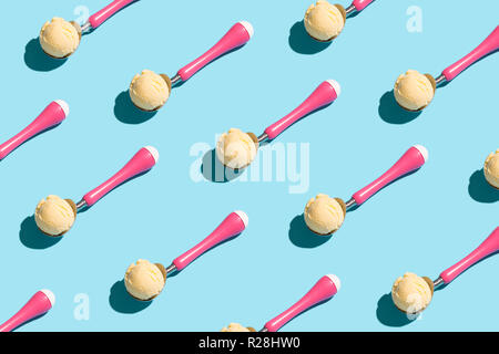 Boules de glace sur glace rose cuillères en mode d'alimentation sur fond bleu. Alimentation mode alimentaire moderne concept. Vue de dessus. Banque D'Images
