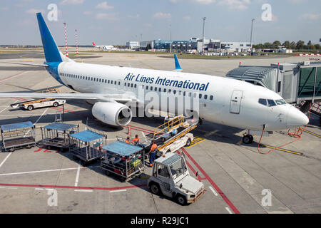 Airplane International Airlines est sur une piste et décharger vos bagages. Préparation de l'avion vol longue distance - long-courriers sur l'aéroport. Banque D'Images