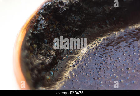 Café noir naturel fraîchement infusé avec de la Mousse au café cuivre traditionnel pot, close-up Banque D'Images