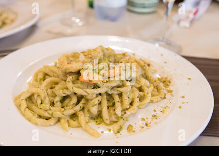 Busiate à la pistache pesto et crevettes servies dans un restaurant en Sicile, Italie Banque D'Images