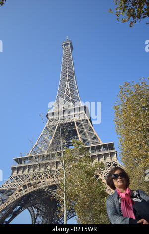 Senior citizen poser pour des photos avec la Tour Eiffel en arrière-plan, Paris, France Banque D'Images