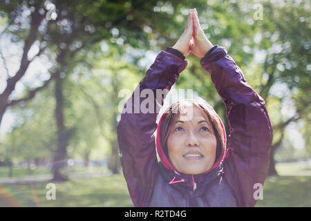 Senior woman practicing yoga in park, Banque D'Images