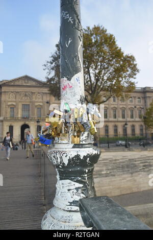 Cadenas d'amour sur le Pont des Arts la passerelle sur la Seine et les personnes marchant sur une passerelle au-dessus de l'RiverSeine face au Louvre Museum Banque D'Images