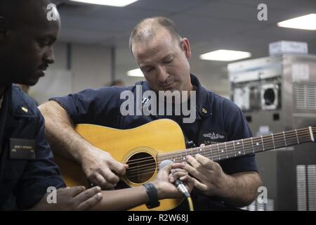 Mer des Caraïbes (nov. 12, 2018) - Le Lieutenant Chris, Ciancitto de Aledo, Texas, effectue une chanson pour remonter le moral, le bien-être, et des loisirs (MWR) talent show à bord du navire-hôpital USNS Comfort (T-AH 20). Le confort est de 11 semaines sur une mission d'appui médical à l'Amérique centrale et du Sud dans le cadre du U.S. Southern Command's Enduring promesse initiative. Travailler avec des partenaires gouvernementaux et de santé en Équateur, au Pérou, en Colombie et au Honduras, l'équipe médicale a entrepris des soins à bord et dans les sites médicaux, aide à relâcher la pression sur les systèmes médicaux causée en partie par une augmentation de la contre- Banque D'Images