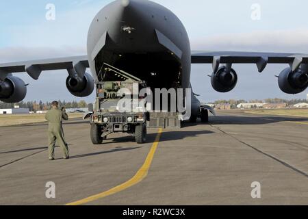 Un aviateur de la 62e Escadre de transport aérien M1167 charge une grande mobilité sur roues polyvalent Véhicule équipé d'un centre directionnel feux à l'arrière d'un C-17 Globemaster, Novembre 15, 2018, at Joint Base Lewis-McChord, dans l'état de la mission a été la première HIMARS (M-142 de l'Armée de haute mobilité Rocket System) à l'infiltration d'air rapide sur les terres du centre de formation de la Yakima nouvelle piste d'atterrissage, Selah, et une partie de sa cérémonie d'ouverture. Le paquet est un HIRAIN HIMARS, qui se compose de deux HIMARS et un centre directionnel Feux, qui est placé sur un C-17 Globemaster et utilisée comme une force de réaction rapide dans le def Banque D'Images