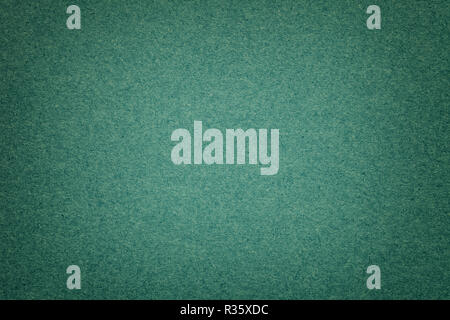 La texture du papier fond vert foncé avec vignette. Structure de l'émeraude dense avec cadre en carton kraft. Toile de gradient estimé libre. Banque D'Images