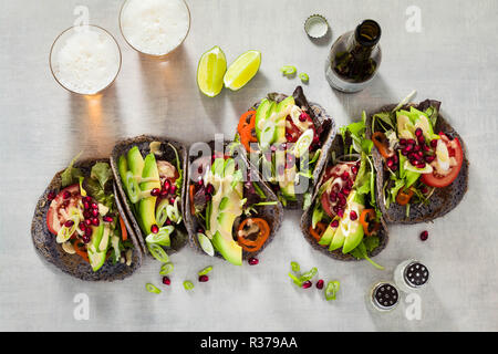 Tacos vegan sans gluten de haricot noir avec de la tomate et d'avocat salade avec sauce tahini et graines de grenade. saine restauration rapide pour l'ensemble de la famil Banque D'Images