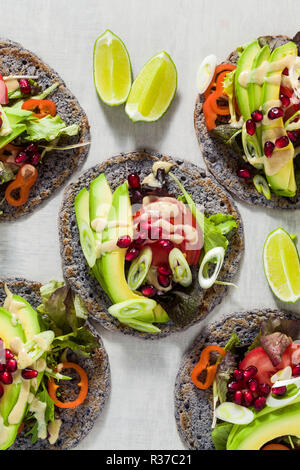 Tacos vegan sans gluten de haricot noir avec de la tomate et d'avocat salade avec sauce tahini et graines de grenade. saine restauration rapide pour l'ensemble de la famil Banque D'Images
