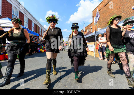 Faversham Hop Festival. Les femmes traditionnelles anglais Folk Dancers, Boxhill Bedlam Morris côté avec black masque yeux peints sur le visage, la danse de rue Ville Banque D'Images