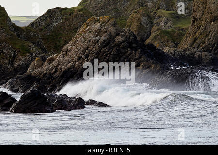 Vagues plus downfaulted les couches de roche basaltique partie du comté d'Antrim Ballintoy côte au comté d'Antrim en Irlande du Nord Banque D'Images