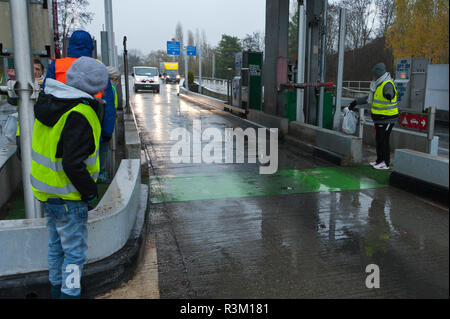 Alby-sur-Chéran, Auvergne-Rhône-Alpes, France. 23 novembre, 2018. Sortie sécurisée des manifestants et permettre aux conducteurs d'une ligne sans frais de sortie. Des militants du "Gilet jaune" mouvement de protestation nationale de prendre part à l'opération "Péage Gratuit" (autoroute gratuite) à la sortie de l'autoroute A41 près d'Alby-sur-Chéran dans l'Auvergne-Rhône-Alpes. Le Gilet "Jaune" est la campagne contre l'imposition d'oppression, en particulier les taxes sur le carburant automobile etc. © Graham M. Lawrenc Crédit : Graham M. Lawrence/Alamy Live News Banque D'Images