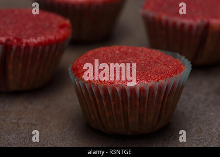 Des muffins betteraves rouges sur fond texturé de métal sombre. Banque D'Images