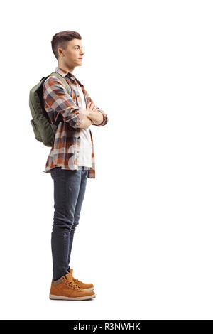 Profil de pleine longueur shot of a young male student standing et d'attente isolé sur fond blanc Banque D'Images