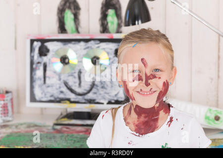 Girl painting des oreilles de lapin sur PC in office Banque D'Images