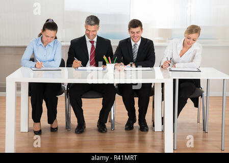 Woman Writing On Clipboard Banque D'Images