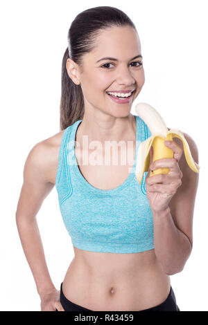 Mettre en place charmante woman eating banana Banque D'Images