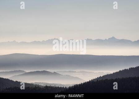 Vue de Tatry Wysokie vont de la montagne Hala Rycerzowa en Beskid Zywiecki montagnes pendant beau jour d'automne avec brouillard dans les vallées et clear sky Banque D'Images