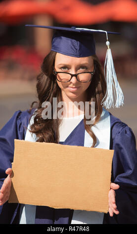 Graduate Carrying Cardboard Sign Banque D'Images
