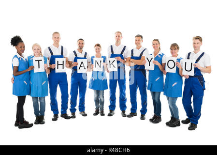 Portrait of smiling woman Holding Concierges Merci Sign Banque D'Images