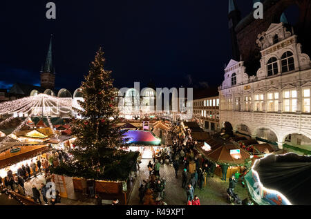 26 novembre 2018, le Schleswig-Holstein, Lübeck : Beaucoup de gens visitent l'hôtel de ville marché de la ville hanséatique de Lübeck le début du marché de Noël. Les premiers marchés de Noël ouvrir le jour après le dimanche de la mort. D'autres suivront dans les prochains jours et certains seront ouverts entre les jours. Photo : Rainer Jensen/dpa Banque D'Images