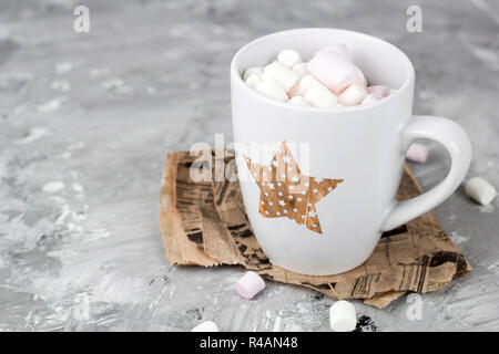 Tasse mignon avec des guimauves sur un fond en béton gris grunge Banque D'Images