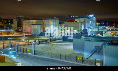 Grain terminal moderne dans la nuit. Les réservoirs métalliques de l'ascenseur. Séchage de céréales construction complexe. Les silos à grains ou semences port maritime. Stockage de l'acier pour la récolte agricole Banque D'Images