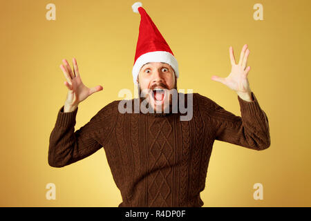 Noël surprise man wearing a santa hat Banque D'Images