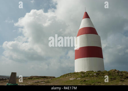 La spectaculaire rouge et blanc à rayures blanche sur le bas, la chapelle de Saint Martin, Scilly, construit en 1683 en tant qu'aide à la navigation la navigation. Soleil avec nuages. Banque D'Images