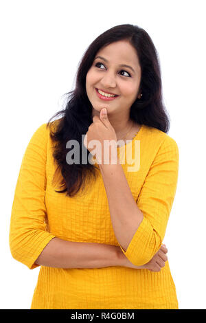 Happy young woman thinking against white background Banque D'Images