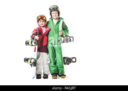 Soeur et frère debout avec les planches à neige isolated on white Banque D'Images