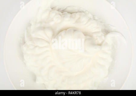 Close up texture de fond de lait crème fouettée fraîche dans un bol blanc, augmentation de la vue supérieure, juste au-dessus Banque D'Images