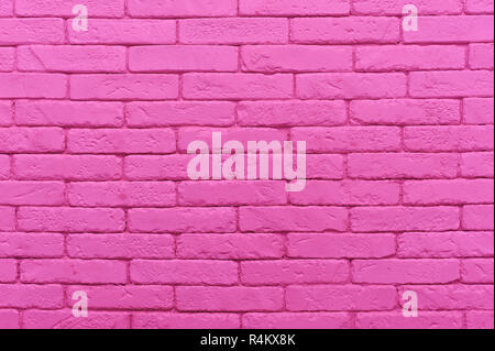 Mur de brique rose pastel peint à la couleur d'arrière-plan texture gros plan. Banque D'Images