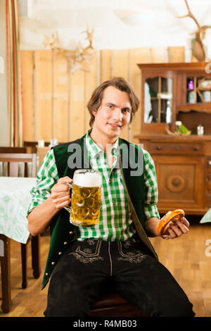 Jeune homme dans le style bavarois Tracht dans restaurant ou pub Banque D'Images