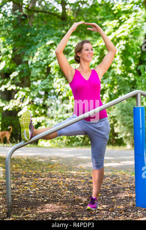 Femme enceinte grossesse faisant yoga sur parcours de santé Banque D'Images