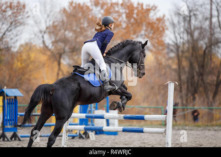 Jeune fille sautant par-dessus avec son cheval obstacle cso sur Banque D'Images