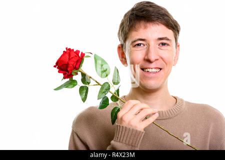 Close up of happy man smiling while holding red rose Banque D'Images