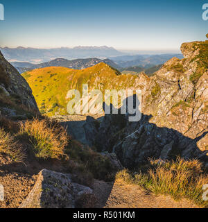 Paysage de montagne à la lumière de soleil couchant. vue depuis le mont Dumbier dans les Basses Tatras, en Slovaquie. Hautes Tatras en arrière-plan. Banque D'Images