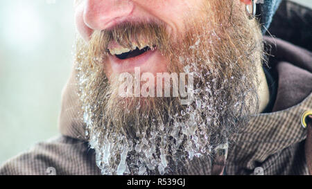 Beard dans les glaçons. Partie du visage d'un jeune homme dans un veston brun. Concept de sports d'hiver à l'air libre. Banque D'Images