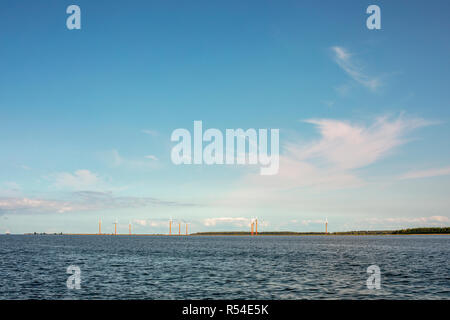 Coloré, orange et rouge, des moulins à vent à Almere Pampus, 10 éoliennes dans un cluster, vu de la mer du Nord, à l'horizon. Banque D'Images