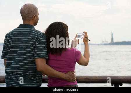 Couple photographing statue de la liberté Banque D'Images