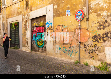 Graffitis colorés ornent un mur de backstreet dans le Trastevere, Rome, Italie. Banque D'Images