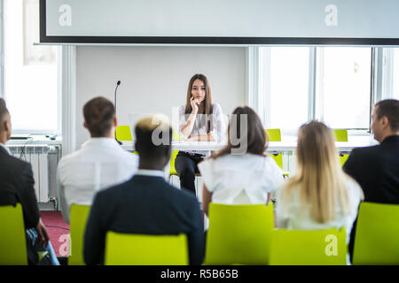 Femme chef d'entreprise asiatique présentant des travaux à mixed race collègues à la réunion Banque D'Images