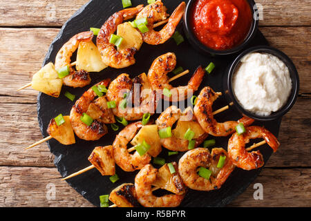 Brochette de crevettes épicées avec de l'ananas servi avec deux sauces sur la table. haut horizontale Vue de dessus Banque D'Images