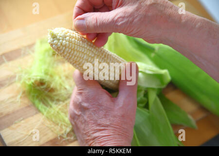 Nettoyage de l'homme maïs frais hors de soie Banque D'Images