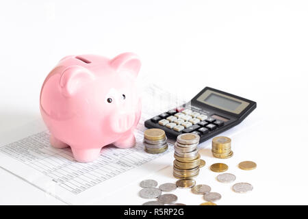 Piggy bank with coins et calculatrice Banque D'Images
