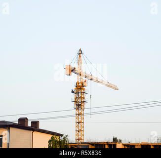 Grue tour bâtiment près de la nouvelle maison en construction. Banque D'Images