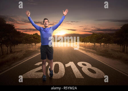 Happy asian man atteindre l'arrivée avec le numéro 2018 de la rue Banque D'Images