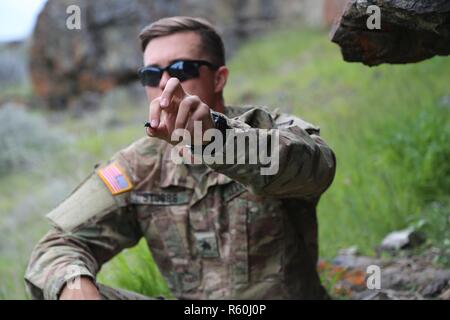 Le sergent de l'armée américaine. Brandon Stubbs, 756e compagnie de munitions (NEM), 184ème bataillon d'artillerie (NEM), 52e Groupe de munitions (NEM), est titulaire d'un scarabée qu'il a trouvé au cours d'une survie, évasion, résistance, et échapper à la classe du centre de formation de la Yakima, Yakima, Washington, 25 avril 2017. Des soldats du 20e de commande formation CBRNE de survie qui a porté sur les besoins de base pour les conditions du désert. Banque D'Images