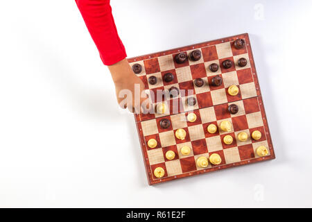 Kid mains sur un échiquier jouant aux échecs. Vue d'en haut Banque D'Images