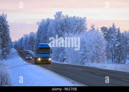 Salo, Finlande - le 21 janvier 2018 : Renault Trucks bleu semi T des transports Sjoman Oy Ab tire la remorque sur une route de campagne à travers les paysages d'hiver au crépuscule. Banque D'Images